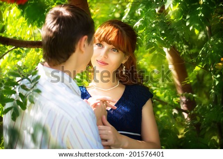 Outdoor portrait of young sensual couple. Love and kiss. Summer vacation concept.