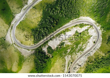 S-curve serpentine mountain road in green forest of Siberia, top down aerial view. Highway R-256 Chuysky Trakt in Altai Republic, Russia Stok fotoğraf © 