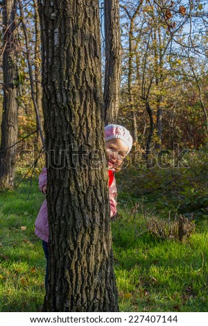 Little girl walks in autumn park