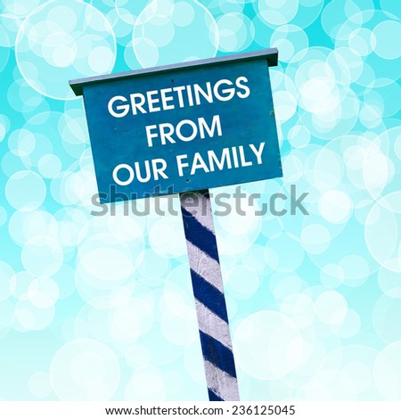 Greetings from our family card written on blue background with defocused lights