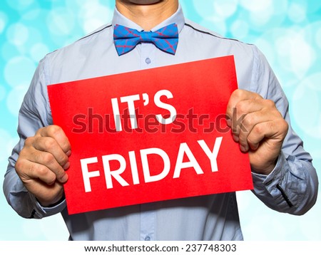 Man holding a card with the text It\'s friday on white background