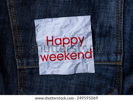 The inscription on the crumpled paper on jeans background Happy weekend