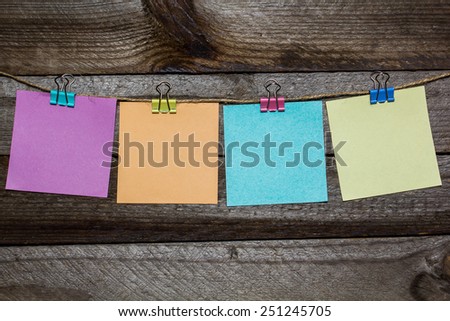 Message written on a paper hanging on the clothesline on wooden background with hearts