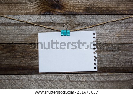 Message written on a paper hanging on the clothesline on wooden background with hearts. valentines day card concept