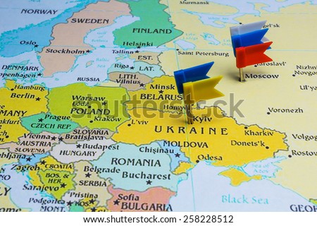 Ukrainian and Russian flags on a country map
