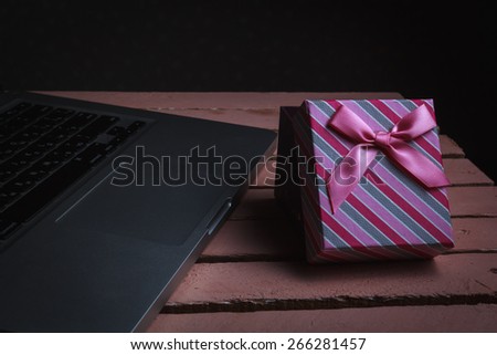 Gift for holiday with computer on vintage background