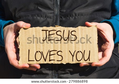 Girl holding a carton paper with text Jesus loves you