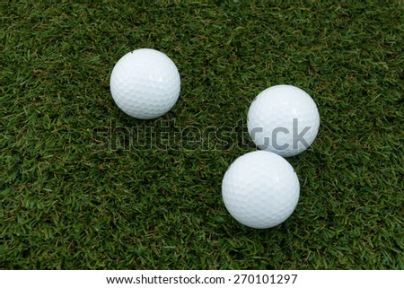 Three Golf ball  on the grass ground.