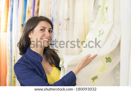 Client in a textiles shop choosing draperies