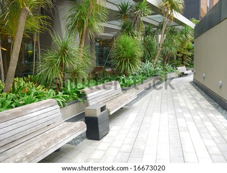 wooden bench in the garden outside office building