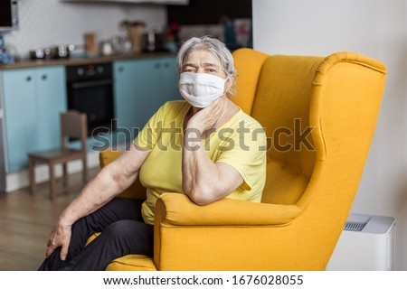 senior old woman in mask quarantine europe. Elderly at risk for coronavirus covid-19. Stay at home. Chinese virus pneumonia pandemic protection grandmother. danger of getting infected