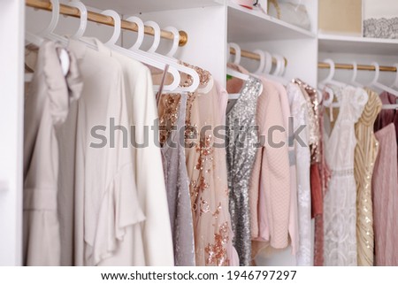 Beautiful female wardrobe. A lot of party dresses hanging on hangers in closet. Vintage clothing rental concept. Women's space. Large selection of various clothes. Small boutique showroom fashion shop Photo stock © 