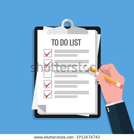 Hand holding pencil and fill check mark on to do lists paper sheet with clipboard and blue background. 