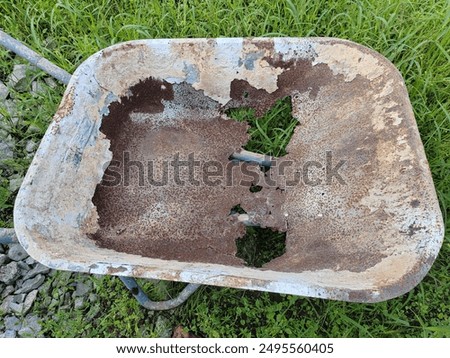 Similar – Image, Stock Photo An old rusty wheelbarrow with a fat black balloon tyre tries to hide in a lilac bush, but doesn’t quite succeed