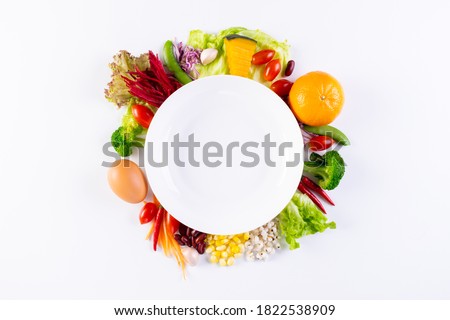 World food day, vegetarian day, Vegan day concept. Top view of fresh vegetables, fruit, with empty plate on white paper background.