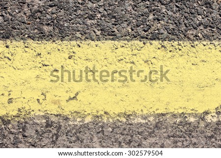 texture of an asphalt road - yellow stripe