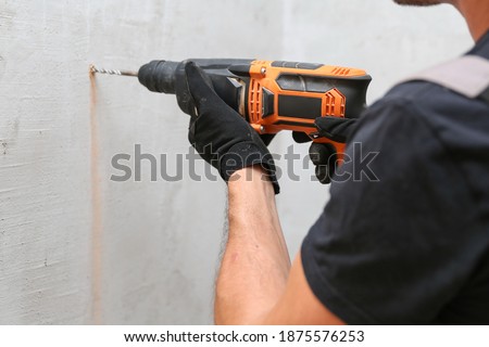 Similar – Image, Stock Photo Man worker drilling wall with hammer drill, top view