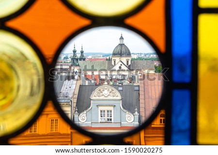 The roofs of Krakow's Old Town through the colored stained glass from the Town Hall Tower on a summer day.  In transparent Circle - St. Anne's Church and tenement house 'Kamienica Pod Jagniemi'. Zdjęcia stock © 