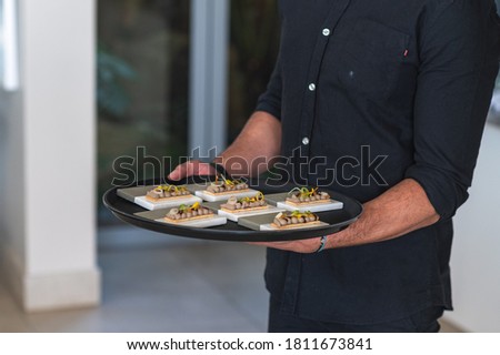 Waiter serving entrées on a tray in a fine dinning restaurant  Сток-фото © 