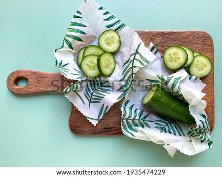 Cucumbers in beeswax food wraps. Eco-friendly and zero waste organic cotton fabric wraps to keep food fresh. Green lifestyle.