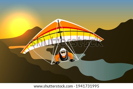 Man having fun on hang gliding extreme sport. Cheerful hang gliding tandem flying in sky