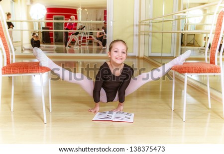 small dancer on a chair with dancing school