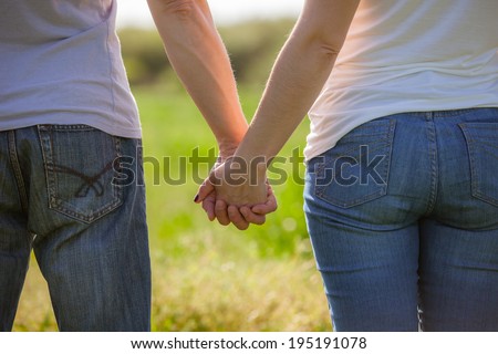 Concept shoot of friendship and love of man and woman: two hands
