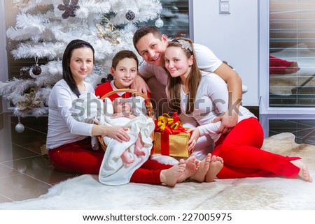Happy young family at the Christmas tree