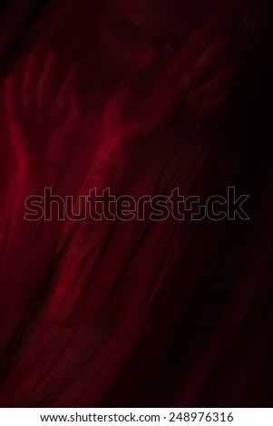 Girl posing with red cloth. Concept, abstraction