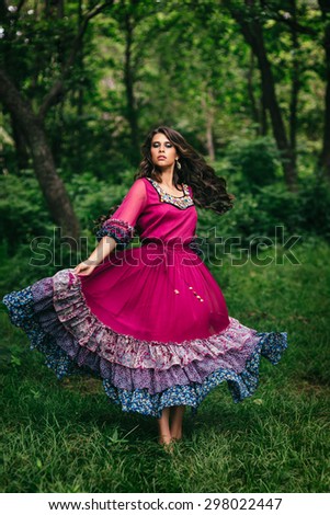 Portrait of a beautiful girl gypsy in violet dress