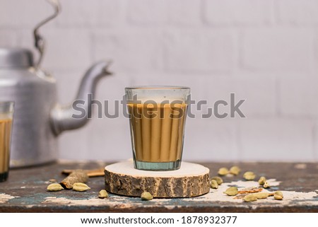 Similar – Image, Stock Photo Glass cup with ginger and lemon tea, on a yellow background along with its ingredients.