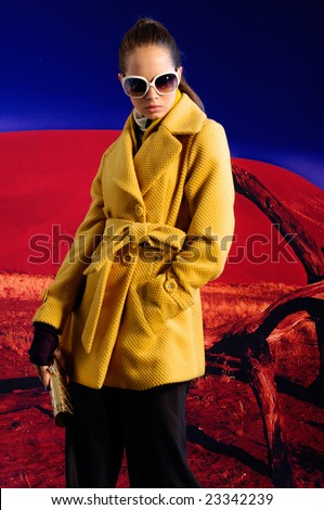 Fashion model in autumn/winter clothes posing on location Namibia, Africa