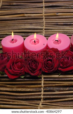 Spa concept. Three Candles and red roses.