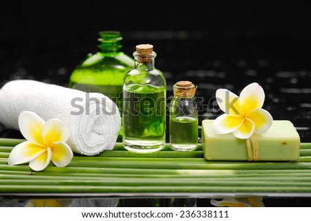 Still life with set of frangipani,candle ,oil with green plant stem
