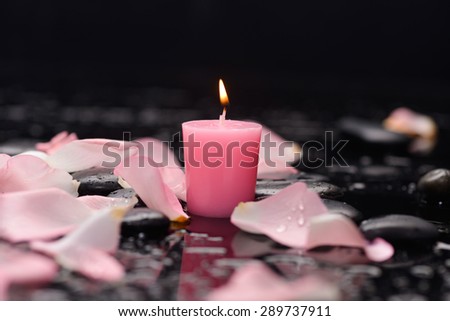 Set of rose petals with candle and therapy stones