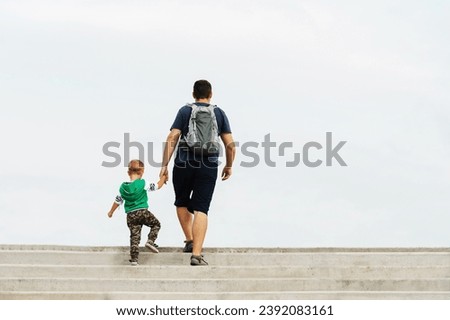 Similar – Image, Stock Photo Unrecognizable traveler walking up hill along road