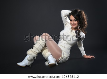 Elegant fashionable woman sitting on a floor