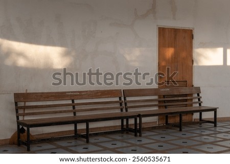 Similar – Image, Stock Photo Plain wooden bench in front of a wooden wall, with a window barricaded with square timbers.