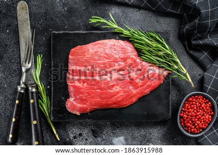 Flat iron steak. Raw Marble beef meat black Angus. Black background. Top view ストックフォト © 