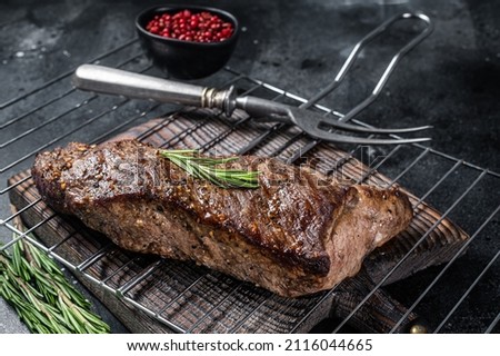 BBQ grilled tri tip beef steak on a grill. Black background. Top view 商業照片 © 