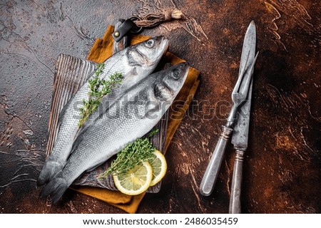 Similar – Foto Bild Zubereitung von Bass-Fischfilets in mediterraner Sauce mit Tomaten, Oliven und Kapern in einer Backform auf rustikalem Holzgrund mit Zutaten. Ansicht von oben