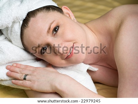 Beautiful Salon Woman Relaxing at Spa with white towel wrapped head