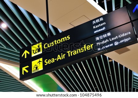 Customs and sea-air transfer signs in Marina Bay Cruise Center Singapore in 4 languages