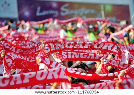 SINGAPORE - AUGUST 09: Sea of Singapore scarves at National Day Parade 2012 on August 09, 2012 in Singapore