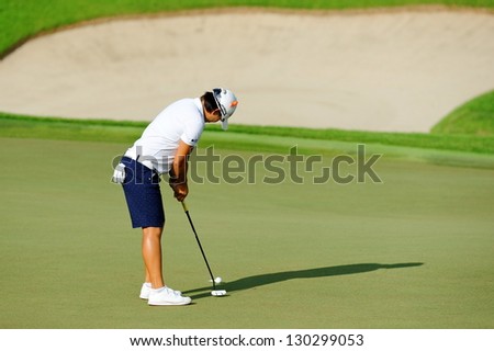 SINGAPORE - MARCH 2: Taiwanese Yani Tseng putting at the green during HSBC Women\'s Champions at Sentosa Golf Club Serapong Course March 2, 2013 in Singapore