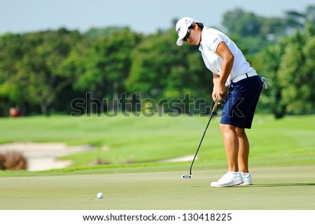 SINGAPORE - MARCH 2: Taiwanese Yani Tseng putting at the green during HSBC Women\'s Champions at Sentosa Golf Club Serapong Course March 2, 2013 in Singapore