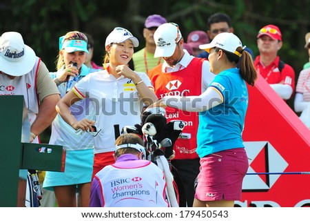 SINGAPORE - MARCH 2: Koreans Hee Kyung Seo and Inbee Park having a casual chat at hole 1 during HSBC Women\'s Champions at Sentosa Golf Club Serapong Course March 2, 2014 in Singapore