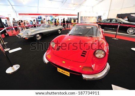 SINGAPORE - APRIL 12: Ferrari Dino 246 GT and Jaguar E-type classic cars on display during Singapore Yacht Show at One Degree 15 Marina Club Sentosa Cove April 12, 2014 in Singapore