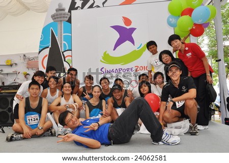 SINGAPORE - JANUARY 10: Group photo of Senior Parliamentary Secretary Mr Teo Ser Luck and athletes during Singapore 2010 Youth Olympic Games logo launch January 10, 2009 in Singapore