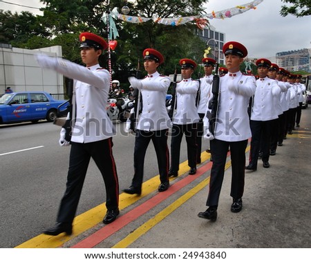 SINGAPORE - DECEMBER 07: Singapore Armed Forces contingent marching on public road during President\'s changing of guards parade December 07, 2008 in Singapore